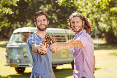 Hipster friends toasting with beers