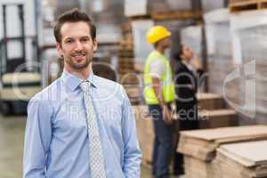 Smiling male manager in warehouse