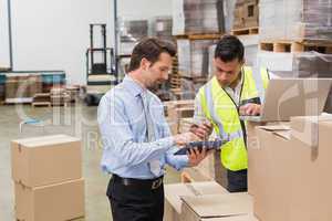 Warehouse worker and manager working together