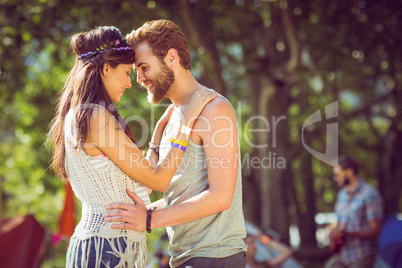 Hipster couple smiling at each other