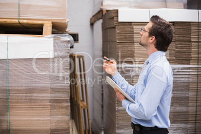 Warehouse manager checking his inventory