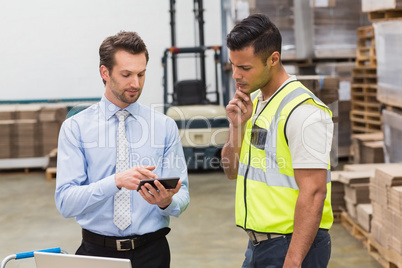 Warehouse worker talking with his manager