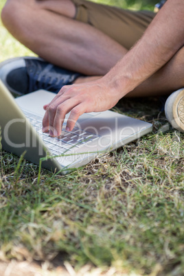 Man using laptop in park