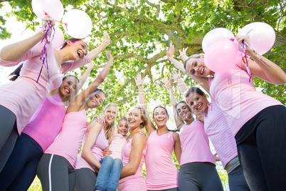 Smiling women in pink for breast cancer awareness