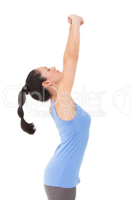 Fit brunette stretching her arms