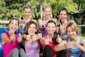 Fitness group smiling at camera in park