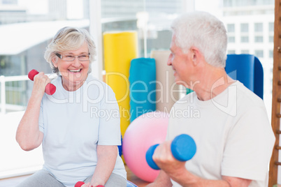 Senior couple lifting dumbbells