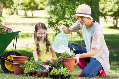 Happy blonde and her daughter gardening