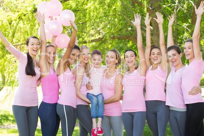 Smiling women in pink for breast cancer awareness