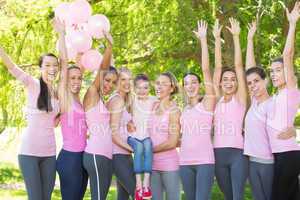 Smiling women in pink for breast cancer awareness