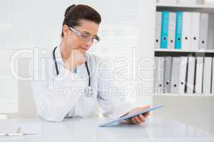 Veterinarian sitting and holding tablet
