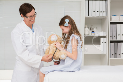 Doctor examining little girl