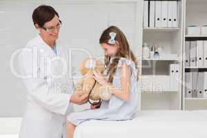 Doctor examining little girl