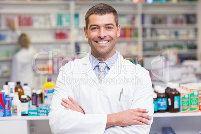 Smiling pharmacist in lab coat looking at camera