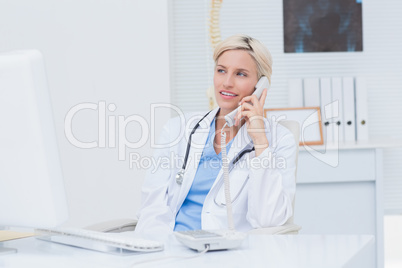 Doctor using telephone at table