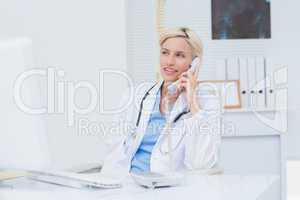 Doctor using telephone at table