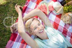 Happy blonde lying and smiling at the camera