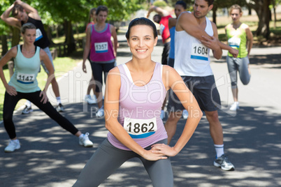 Smiling woman warming up before race