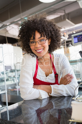 Pretty waitress with glasses leaning on counter