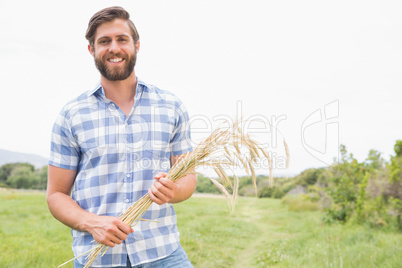 Happy man with his sheaf of wheat