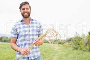 Happy man with his sheaf of wheat