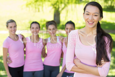 Smiling women in pink for breast cancer awareness