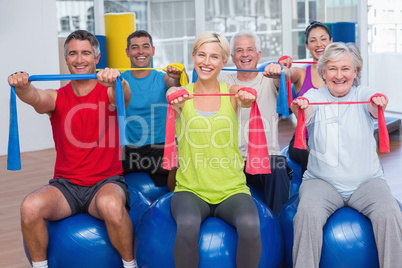 People exercising with resistance bands in gym class