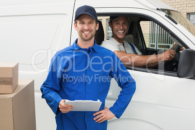Delivery driver checking his list on clipboard with client