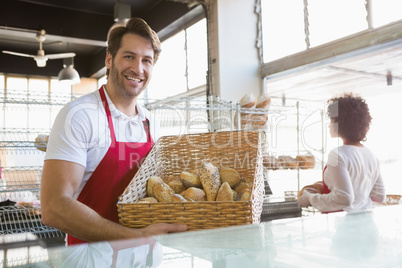 Smiling water carrying basket of bread