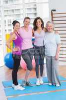 Portrait of happy women standing arms around