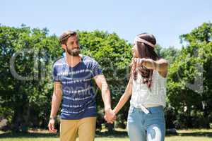 Hipster couple walking in the park