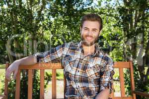 Handsome hipster relaxing in the park