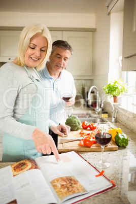 Mature couple preparing vegetables together