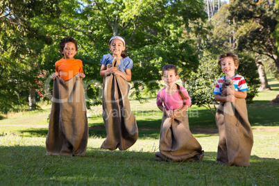 Children having a sack race in park