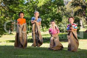 Children having a sack race in park