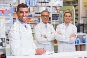 Team of pharmacists smiling at camera