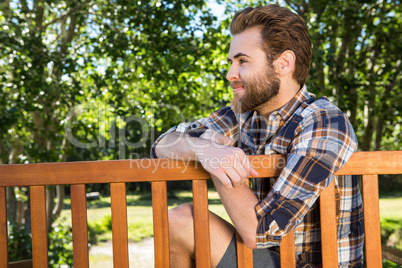 Handsome hipster relaxing in the park