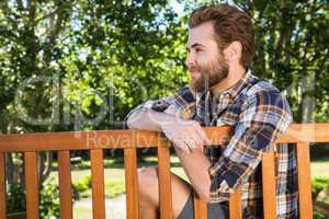 Handsome hipster relaxing in the park