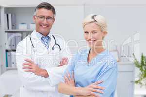 Nurse and doctor standing arms crossed at clinic