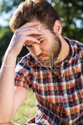 Handsome hipster feeling sad