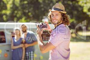 Hipster taking a photo of his friends