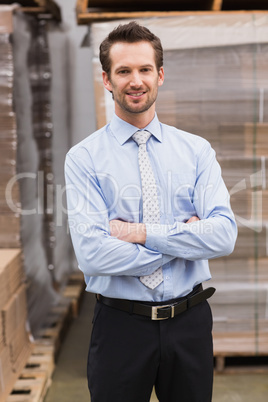 Smiling manager with arms crossed