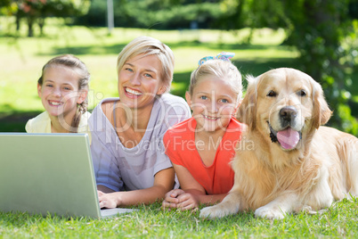 Happy family and their dog smiling at the camera