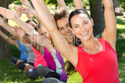 Fitness group doing yoga in park