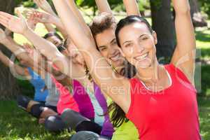 Fitness group doing yoga in park