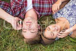 Couple relaxing in the park on their phones