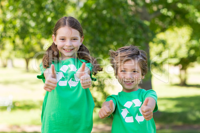 Happy siblings in green with thumbs up