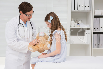 Doctor examining little girl