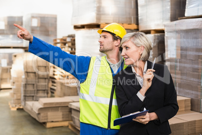 Warehouse worker and his manager working together