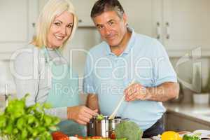 Happy mature couple making dinner together